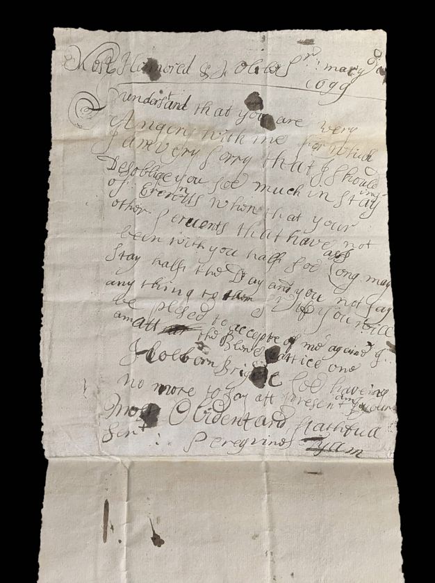 A historical handwritten letter on aged, yellowed paper featuring elegant cursive script. The ink shows signs of fading and blotting, common in documents from earlier centuries. The letter contains lines of text, with visible creases and a tear along one edge, suggesting it has been folded and handled extensively. The top part of the document includes a formal address, while the closing is marked with a signature. The overall appearance indicates the document's antiquity and significance.