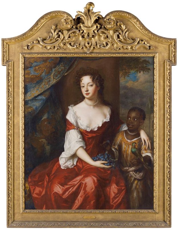 A 17th-century oil painting depicting a seated woman in an elaborate red gown with white sleeves, holding a cluster of grapes. The woman is adorned with a pearl necklace and earrings. Beside her stands a young child, also adorned with pearls, holding a small parrot. The background features a luxurious blue and gold drapery and a landscape with trees. The painting is framed in an ornate gold frame with intricate designs.