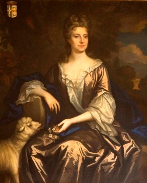 Portrait of an 18th-century woman seated in an outdoor setting. She is dressed in a silk gown with voluminous sleeves and a blue shawl draped over her lap. Her right hand gently rests on a small brown and white sheep, while her left hand holds a small bouquet of flowers. The background features a dark, natural landscape. The subject's expression is calm, and a coat of arms is visible in the top left corner.