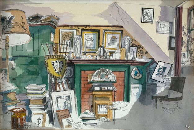 An eclectic interior scene showing a cluttered room with a green cabinet, a slanted ceiling, and a variety of framed pictures and artifacts. A green mantle above a brick fireplace displays small sculptures and objects. Stacks of books are scattered throughout the space, with a prominent yellow shield to the left.