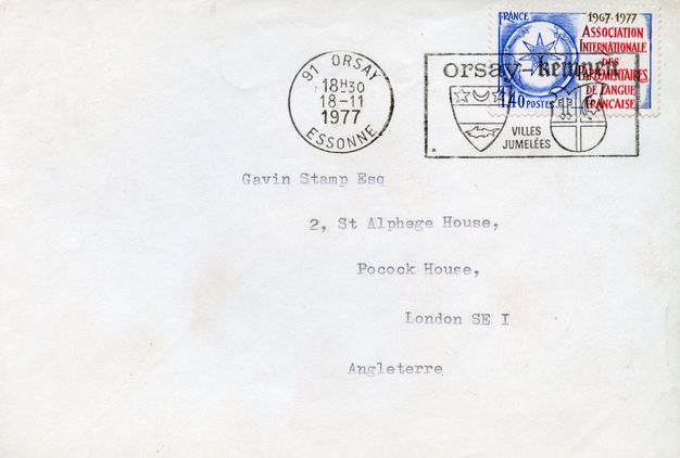 White envelope with a blue and red french stamp at the top right, stamped in black ink twice by the French postal service, and typed font that reads "Gavin Stamp Esq / 2, St. Alphege House / Pocock House / London SE I / Angleterre".